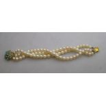 A three-row cultured pearl uniform bracelet having 18ct yellow gold flower style clasp set cabochon
