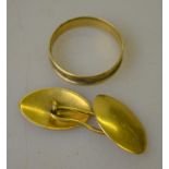 Two pieces of unmarked yellow metal, a cufflink and ring,