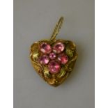 A Victorian heart shaped pendant having pink tourmaline pansy in centre in coloured gold setting