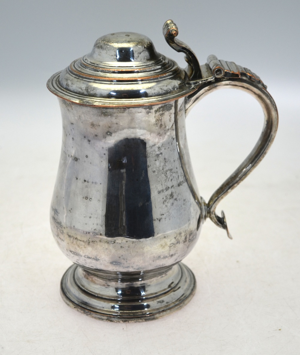 A mid Georgian Old Sheffield Plate lidded tankard of baluster form with foliate and scroll