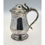 A mid Georgian Old Sheffield Plate lidded tankard of baluster form with foliate and scroll