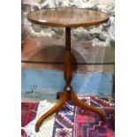 A Sheriton Revival satinwood tripod wine table, the circular top with lip edge and decorative band,