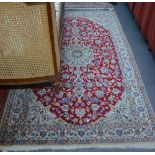 A Persian part silk Nian rug, the red ground centred by a centre flower medallion, 2.10 x 1.