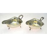 A pair of silver sauce-boats of rounded triangular form with egg and dart rims,