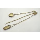An Edwardian silver chatelaine with cast and pierced rococo revival clip and three fancy link