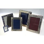 Two embossed silver-faced photograph frames, 23 x 17 cm, and another stamped 925, 18 x 14 cm,