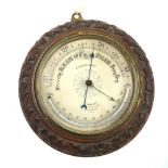 A Victorian aneroid barometer with 20 cm silvered dial and curved mercury thermometer,