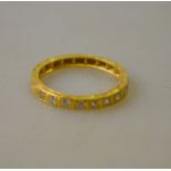 A diamond set half eternity ring with engraved shank and shoulders,