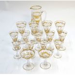 A set of Victorian gilded glasses with a carafe en-suite,