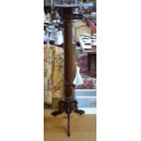 A mahogany foliate-carved and spiral reeded torchère, on later tripod base.