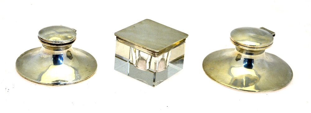 Two weighted silver capstan inkwells,