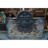 A 19th century cast iron fire back having a relief royal cypher decoration,