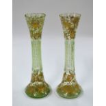 A pair of 19th century Continental pale green glass vases with long waisted necks,
