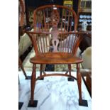 A 19th century yew and elm wheel back Windsor elbow chair,