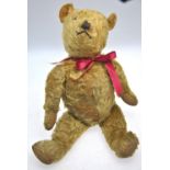 A gold plush mohair teddy bear with stitched nose and mouth,