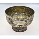 A late Victorian heavy quality silver rose bowl, richly embossed and chased with foliage,