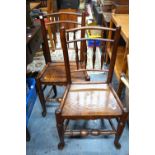 A set of four elm side chairs with spindle backs over single piece plank seats,