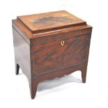 A Regency featherbanded mahogany cellarette, the hinged caddy top enclosing a vacant interior,