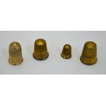 Four various gilt metal thimbles