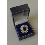 A cabochon sapphire and diamond cluster ring,