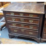 An 18th century oak chest of four long graduated drawers having applied moulded edges and raised on