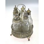 A George III silver circular cruet stand with beaded loop handle and honeysuckle-pierced gallery,