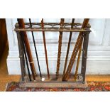 A Victorian style cast iron six circular division stick stand with removable drop tray in the