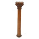 A Victorian carved waxed pine pillar with corinthian capitol,