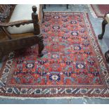 An old Persian Hamadan rug, the field of diamond lozenges on red ground,