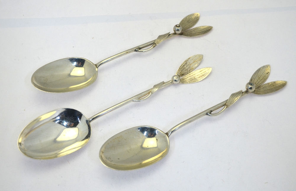 A pair of silver 'Christmas' table spoons, the handles worked mistletoe leaves and berries,
