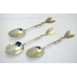 A pair of silver 'Christmas' table spoons, the handles worked mistletoe leaves and berries,