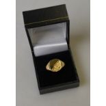 A 9ct yellow gold signet ring with part textured head,