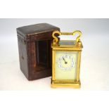 A brass carriage clock with enamel dial, 11.