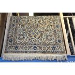 A Persian Nian rug, the cream ground with centre medallion and trailing vine design in blue grey, 2.