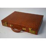 A dark tan ostrich leather attache case with Hodges combination lock (lock instructions inside),