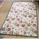 A classic style needlepoint wool rug, the field of stylised flower heads on mocca ground, 1.82 x 1.