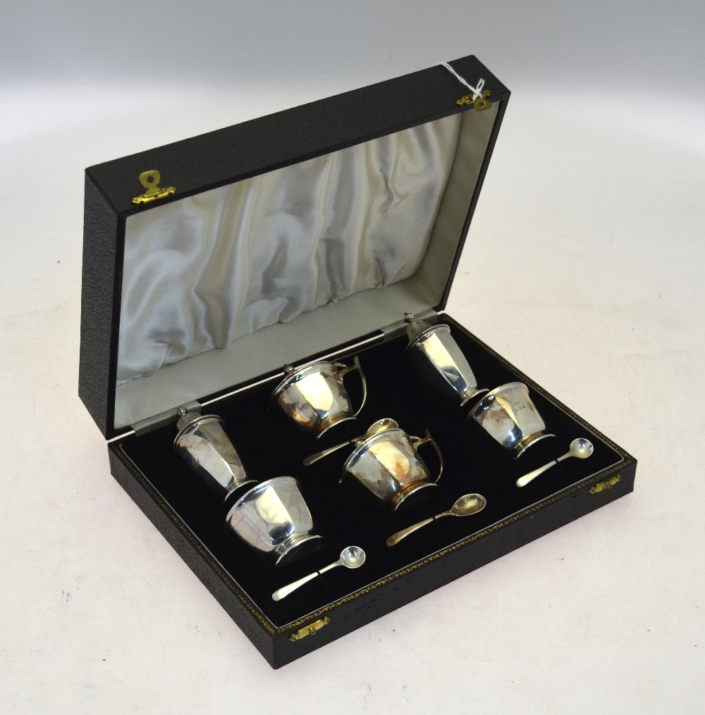 A cased silver six-piece condiment set with blue glass liners and the spoons, Mappin & Webb,