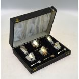 A cased silver six-piece condiment set with blue glass liners and the spoons, Mappin & Webb,