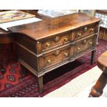 A 17th/18th century oak chest of two over two short moulded front drawers beneath a shaped top,