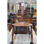 A pair of close matched yew and elm Windsor elbow chairs with hoop backs and fret-cut splats,