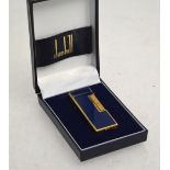 A boxed Dunhill Rollagas gilt metal cigarette lighter with simulated lapis enamel