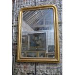 A Victorian gilt framed overmantel, the arched plate with beaded all-round slip,