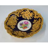 A Meissen circular dish, cobalt blue ground with gilt moulded floral and foliate decoration,