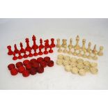 A turned and dyed bone chess set, to/w a matching set of draughts, height of king 7.