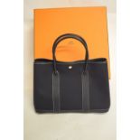A black canvas and leather Garden Party Tote Bag with box and keeper bag,