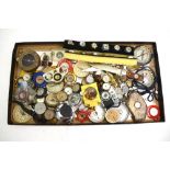 A large collection of novelty pocket compasses