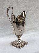 A George III silver helmet shaped cream jug, with swag decoration on a square foot, London, 1791,