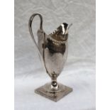 A George III silver helmet shaped cream jug, with swag decoration on a square foot, London, 1791,