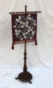 A Victorian rosewood pole screen, the beadwork screen decorated with flowerheads and leaves,