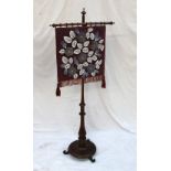 A Victorian rosewood pole screen, the beadwork screen decorated with flowerheads and leaves,